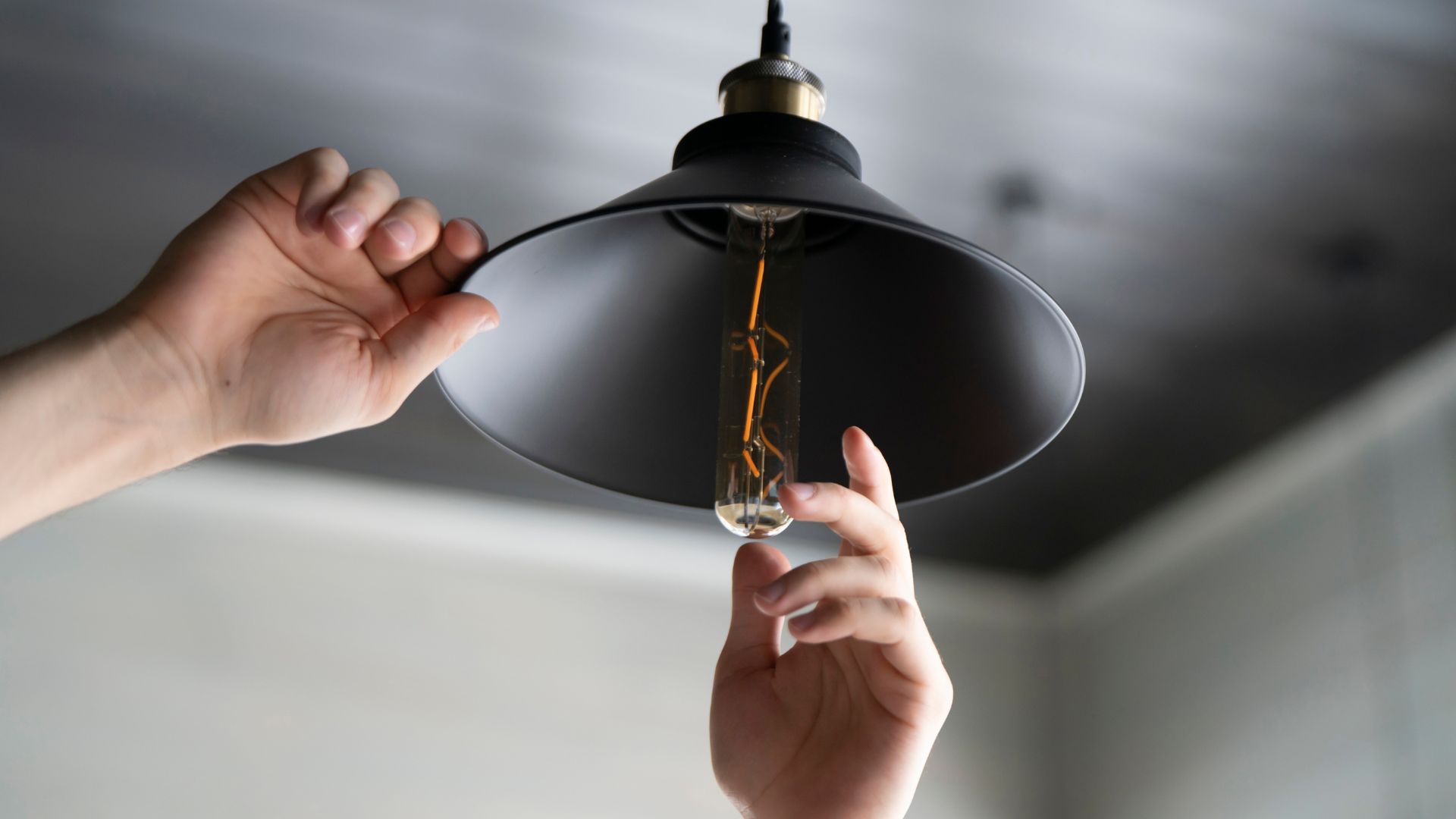 lighting82324-4 picture of someone changing a light bulb